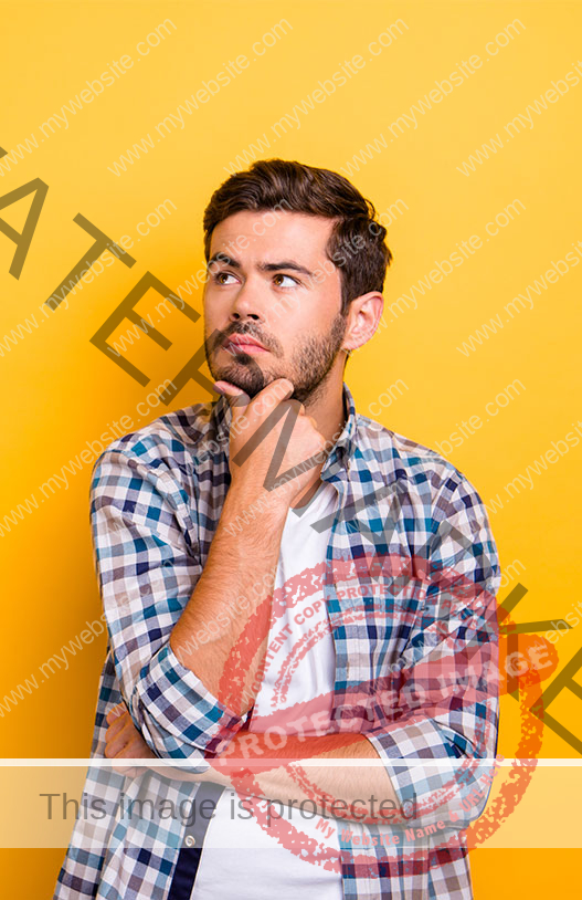 Guy in front of orange background in thinking position