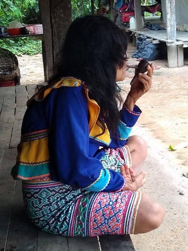 Peruvian female shaman smoking tabacco