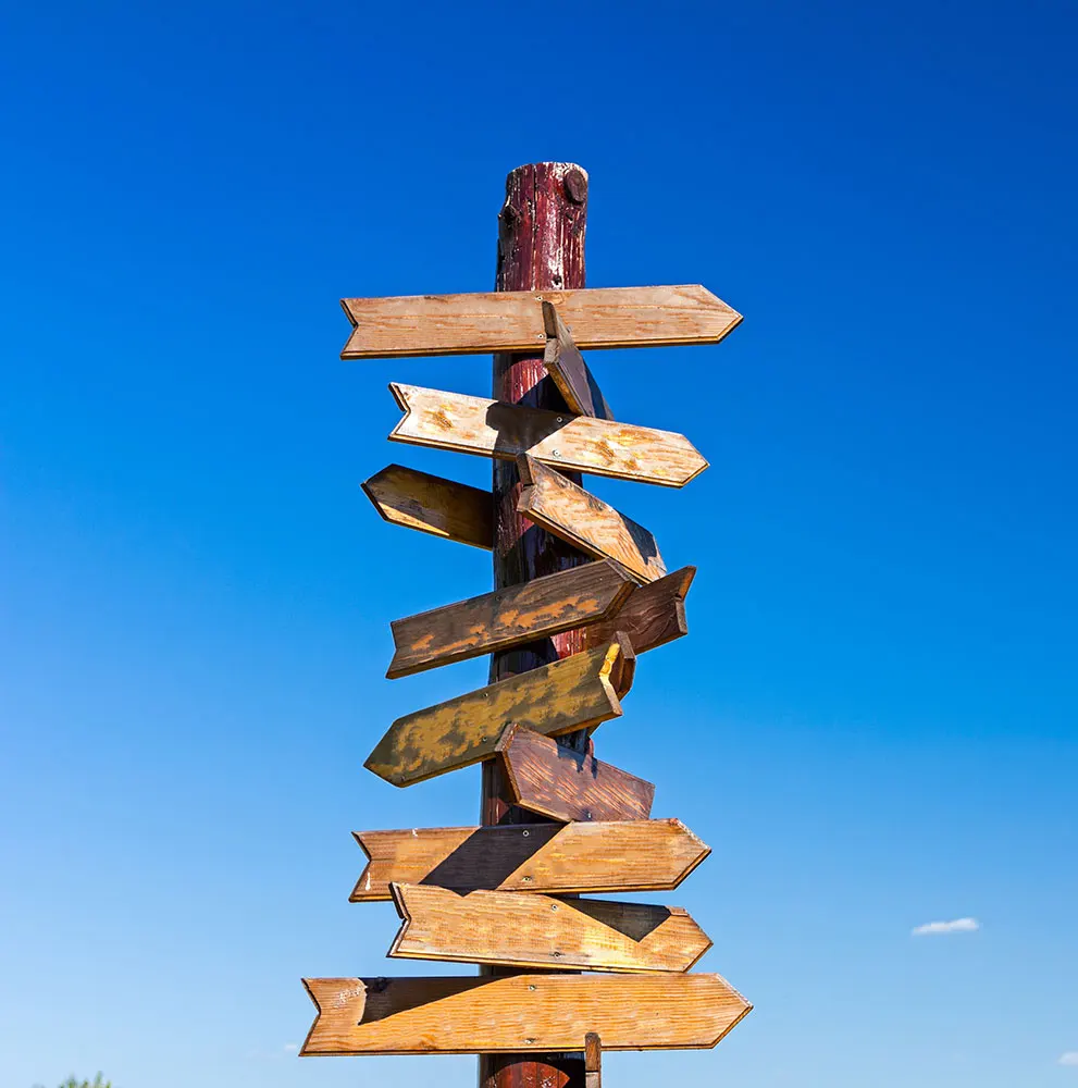 a wooden sign with many directions