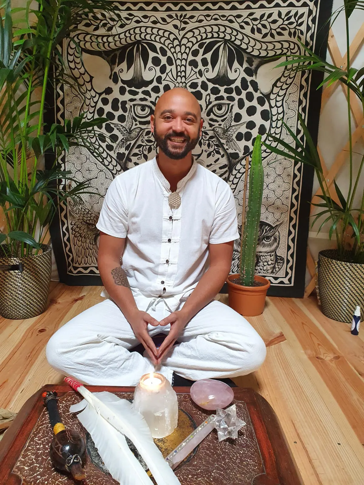 Shurandy wearing white clothes sitting in meditation position in Yurte