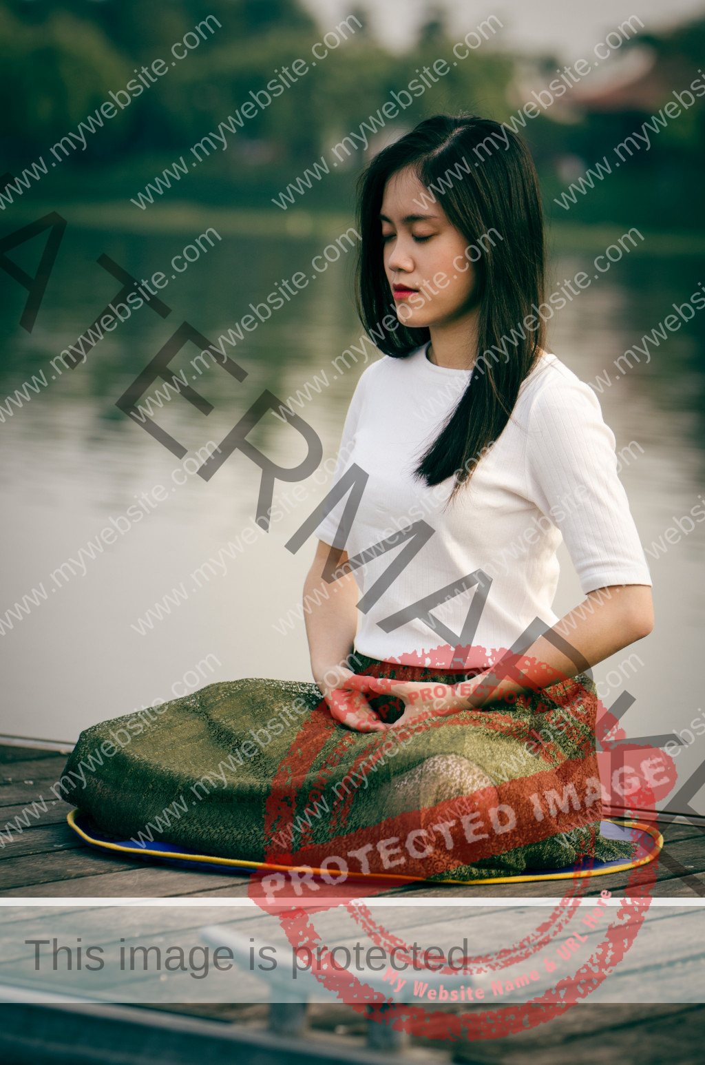 Asian woman meditating sitting at a lake