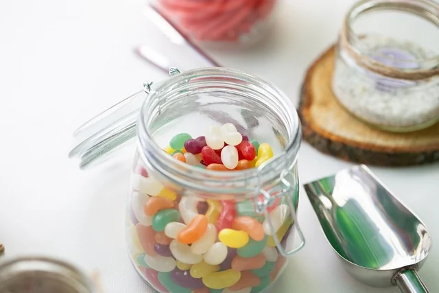 Gummies in a glas jar on white table