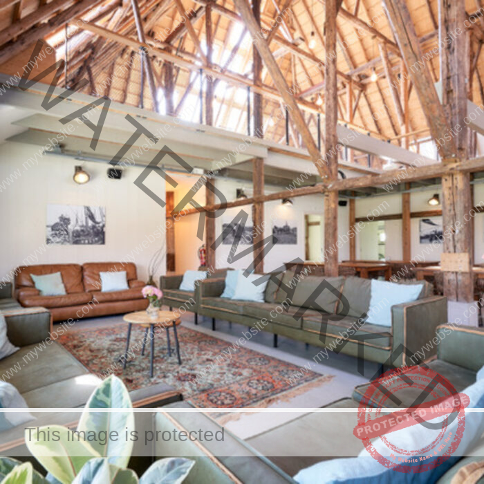 Huge living room with 4 couches and high wooden roof