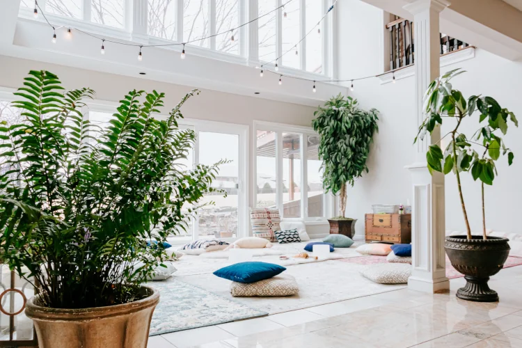 Meditation room with many windows and pillows