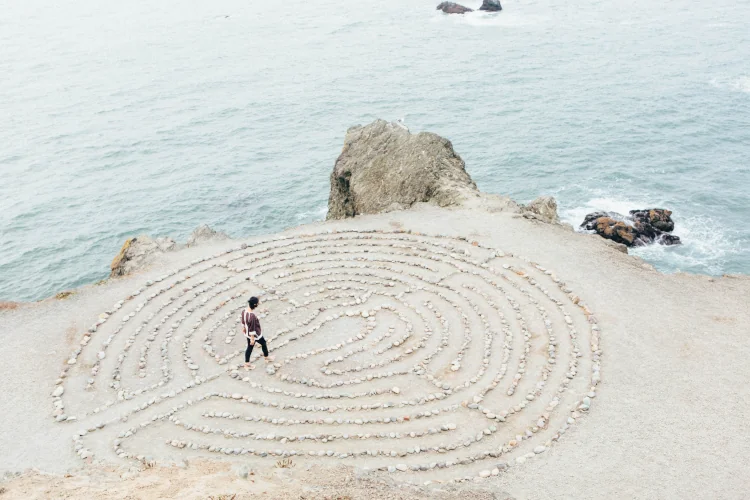 Stone circle at the coast with a person stepping inside
