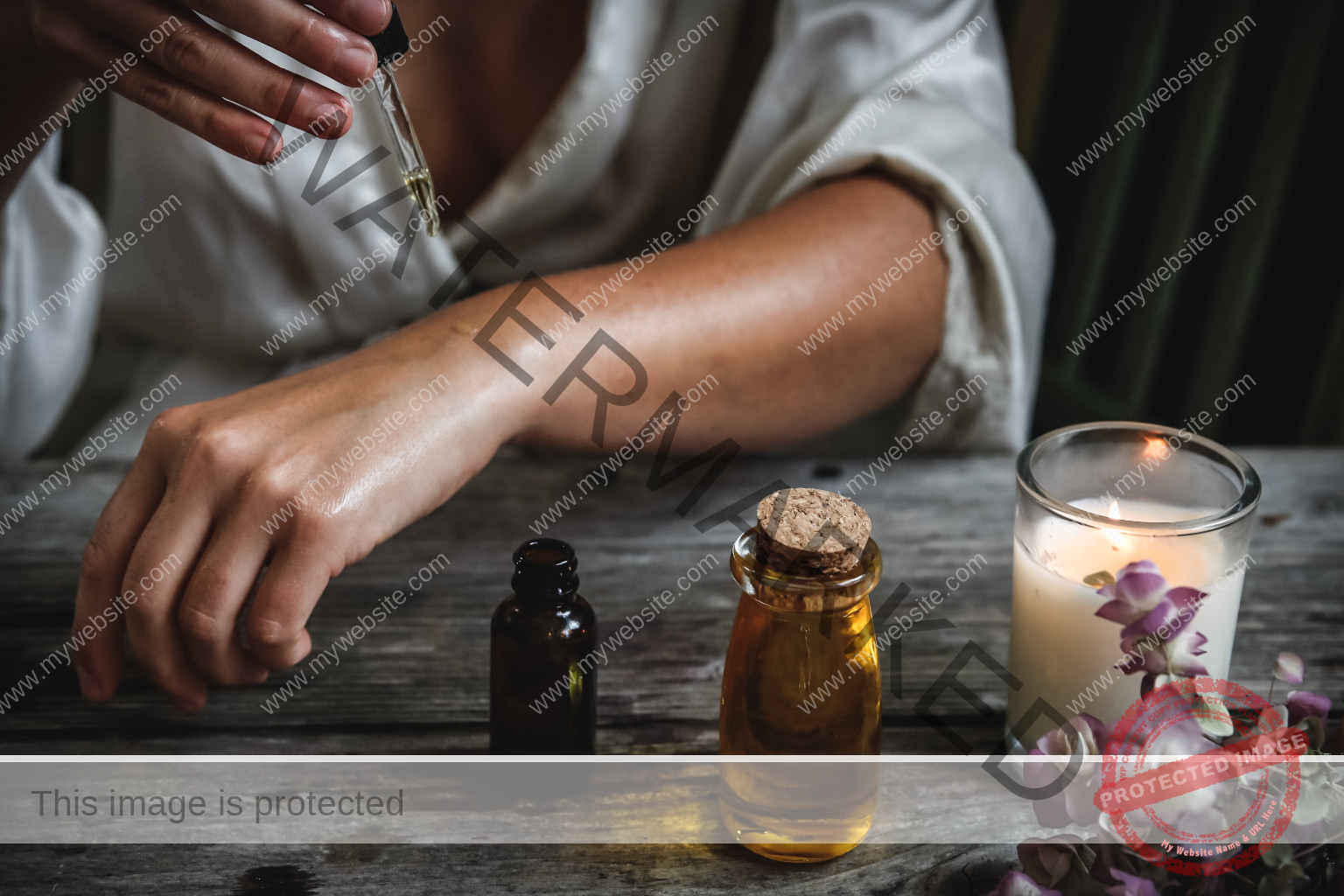 Woman dropping oil on her hand on a table