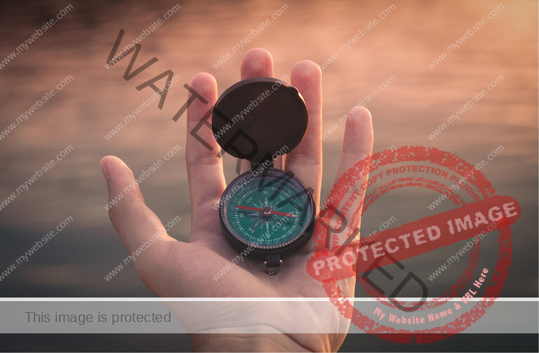 A hand is holding a compass outside