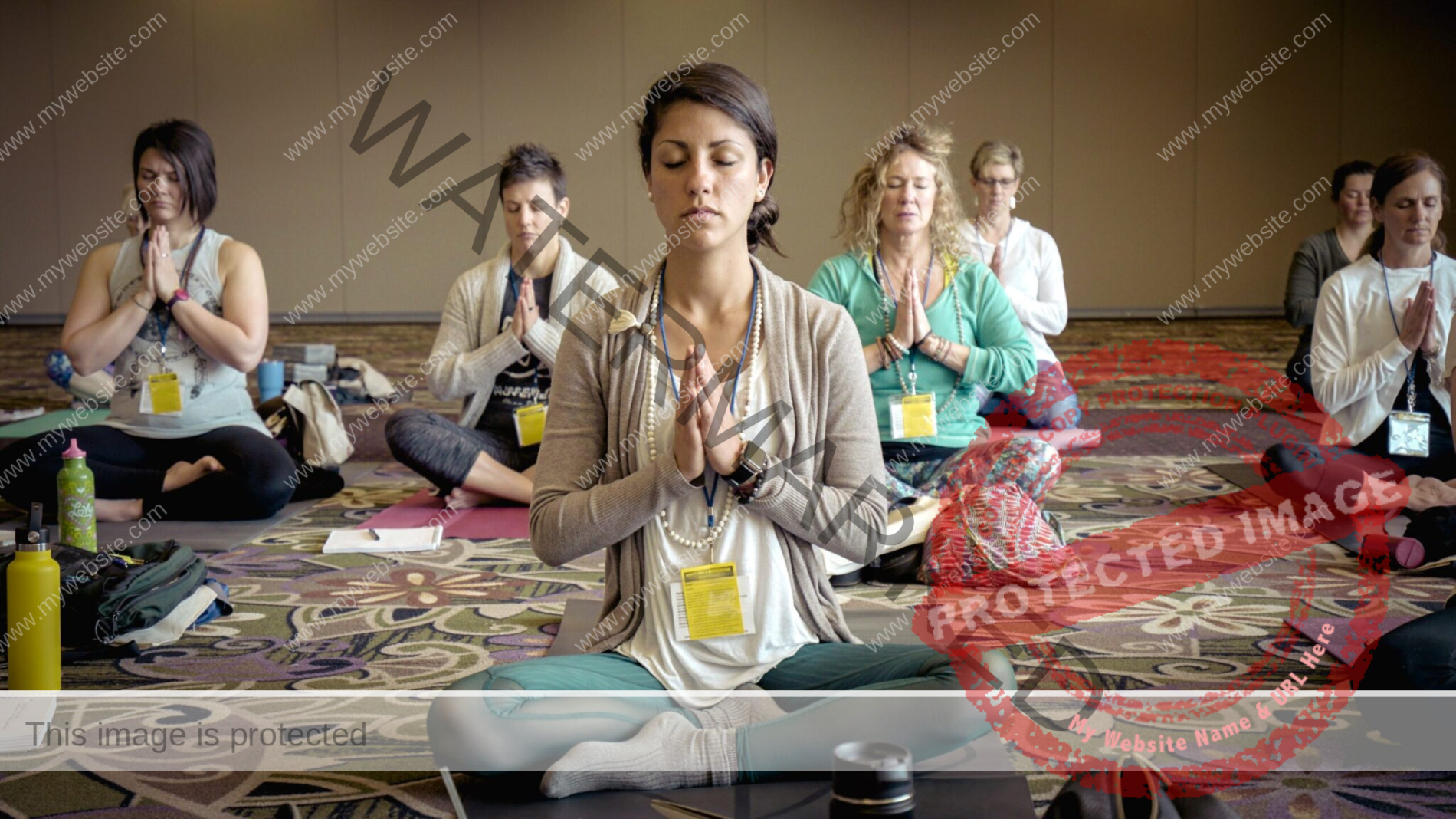 group of people meditating with their hands on their hearts