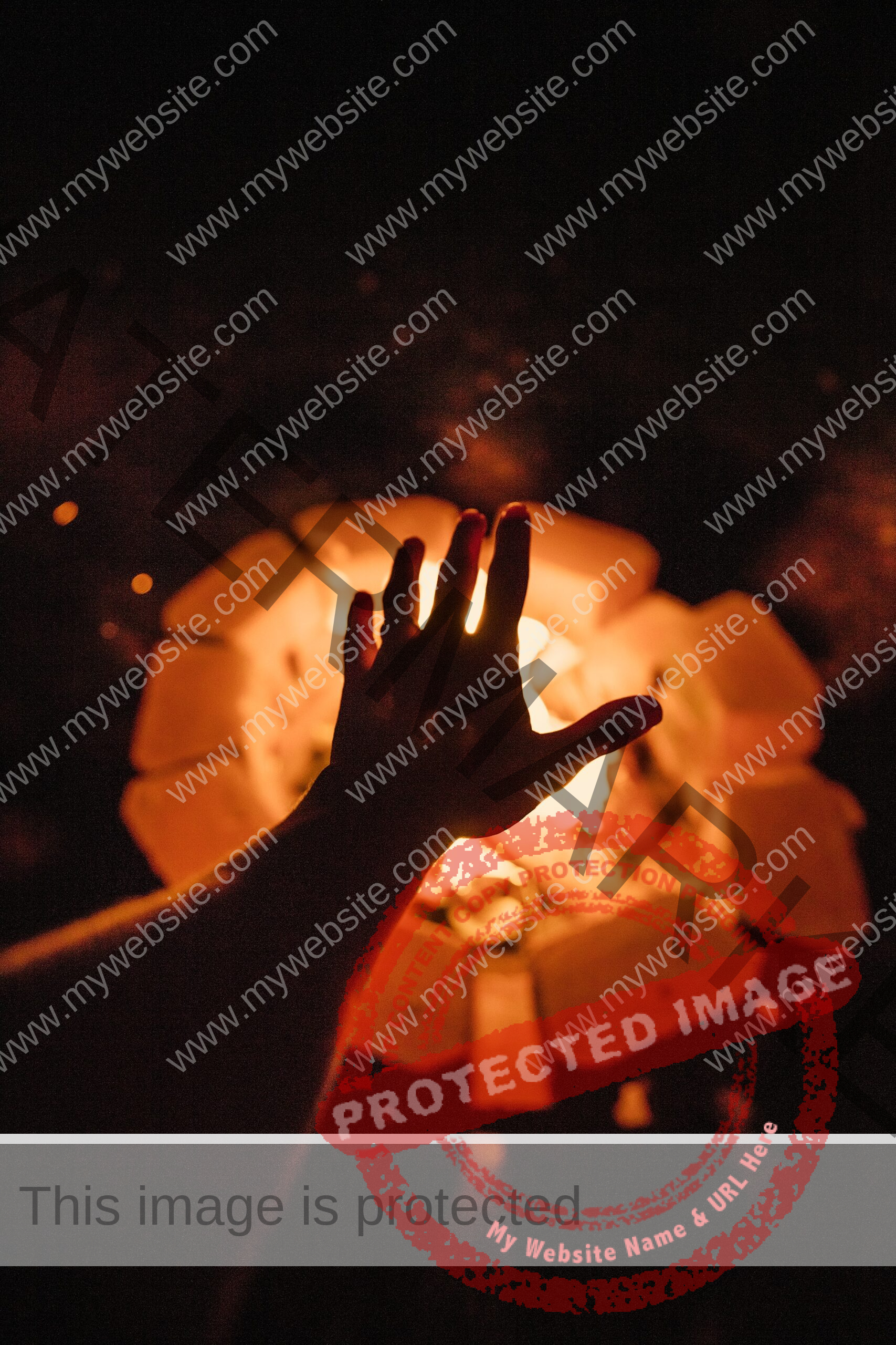 silhouette of a hand in front of an outdoor fire pit