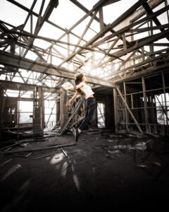 woman suspended in the air in an abandoned industrial nbuilding