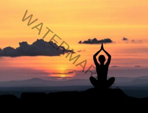 silhouette of a person in front of a sunset in meditation yoga pose