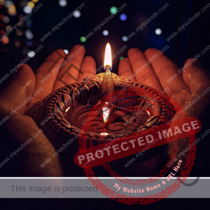 Lighted Candle holded in hands, stars in the background