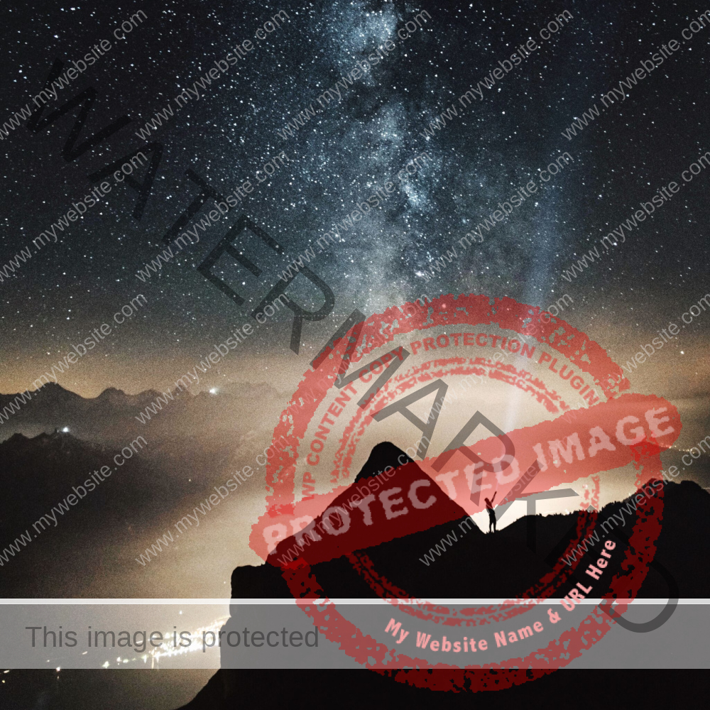 silhouette of a man on mountain with the milkyway galaxy in the sky