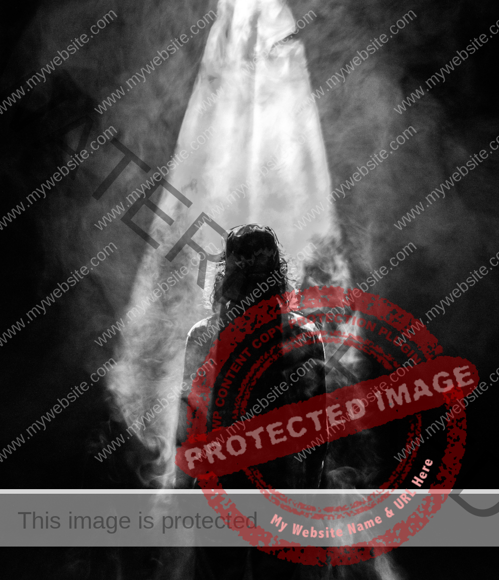 Guy with long hair standing with his back in smoke, light shining from above