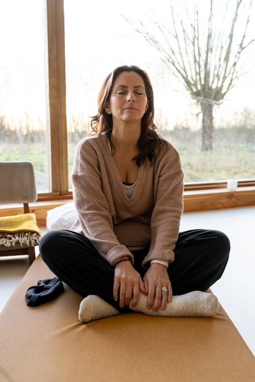 Woman meditating on mattress