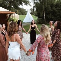 Women circle, holding theire hands and enjoing the moment in peace and calmness