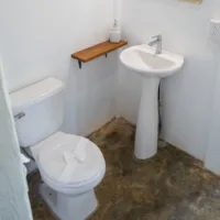 En-suite bathroom with toilet and sink in private bungalow