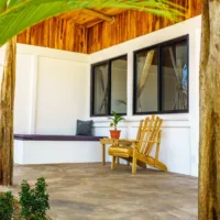 Private bungalow terrace with wooden chair and sitting area