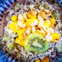 Close up of sweet salade with kiwi and mango pieces