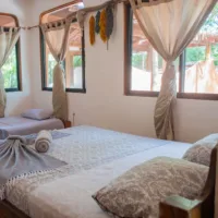 Private bedroom with double bed and single bed