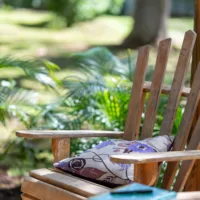 Wooden chair with pillow and little table