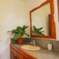 Private bathroom with one sink and mirror