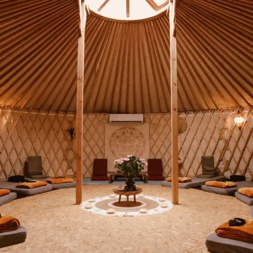 Traditional Yurt from inside, natural and warm light, mattresses placed in a circle